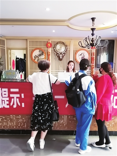 吴女士、金女士等人正在询问酒店是否有空房。本报记者  王若英  摄