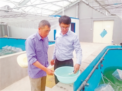 <p>　　王永利（右）指导水产养殖户进行水质盐度测试。</p>