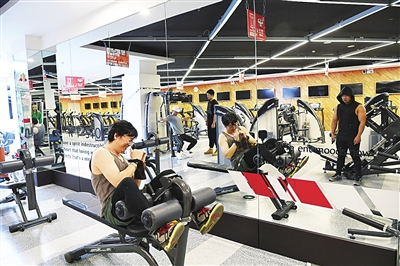     健身达人在器械上锻炼身体。