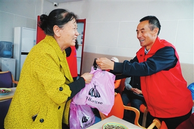 宁夏铁发人力资源服务有限公司书记丁万林为贫困老人送上中秋节礼物。 

    本报记者　吴彩华  摄