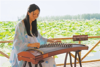 <p>　　7月14日，一名身穿汉服的女子在银川鸣翠湖国家湿地公园荷花池旁弹奏古筝。7月18日，银川市第二届湿地生态文化旅游节暨鸣翠湖第四届荷花节将正式启幕。　　　　　　　　　　　　　　　　　　　　　　　　　　　　　　　　　　　　　　　　　　　　　　　　　　　本报记者　张唯　张瑛　摄</p>