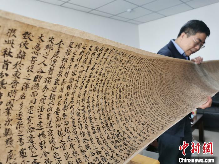 2020年9月底，读者集团敦煌文艺出版社社长展示《敦煌法藏文献》的复制品。(资料图) 闫姣 摄