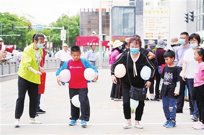 5月29日，银川市兴庆区前进街街道办在新百老大楼商场前举行趣味运动会。跳绳、运球、你来比划我来猜……居民们玩得不亦乐乎。 本报记者  武晓瑜  摄