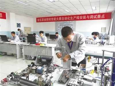 <p>　　学生们在自动化生产线安装与调试比赛项目中紧张作业。</p>